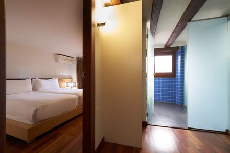 Bathroom and bed of the Mercer House Bòria BCN